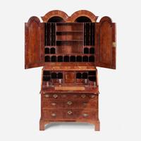 A Queen Anne inlaid and veneered walnut double-dome bureau bookcase circa 1720