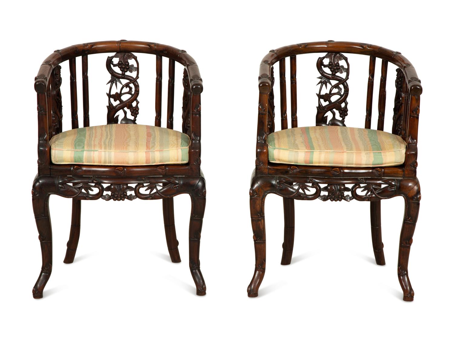 A Pair of Chinese Hongmu Horseshoe Back Carved Armchairs