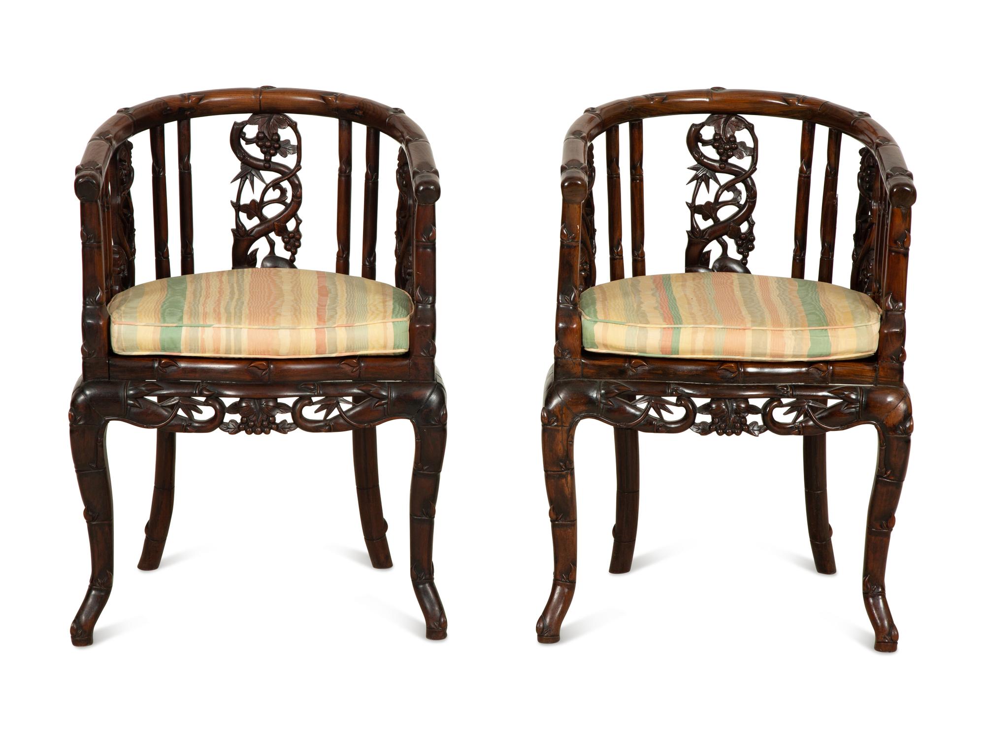 A Pair of Chinese Hongmu Horseshoe Back Carved Armchairs