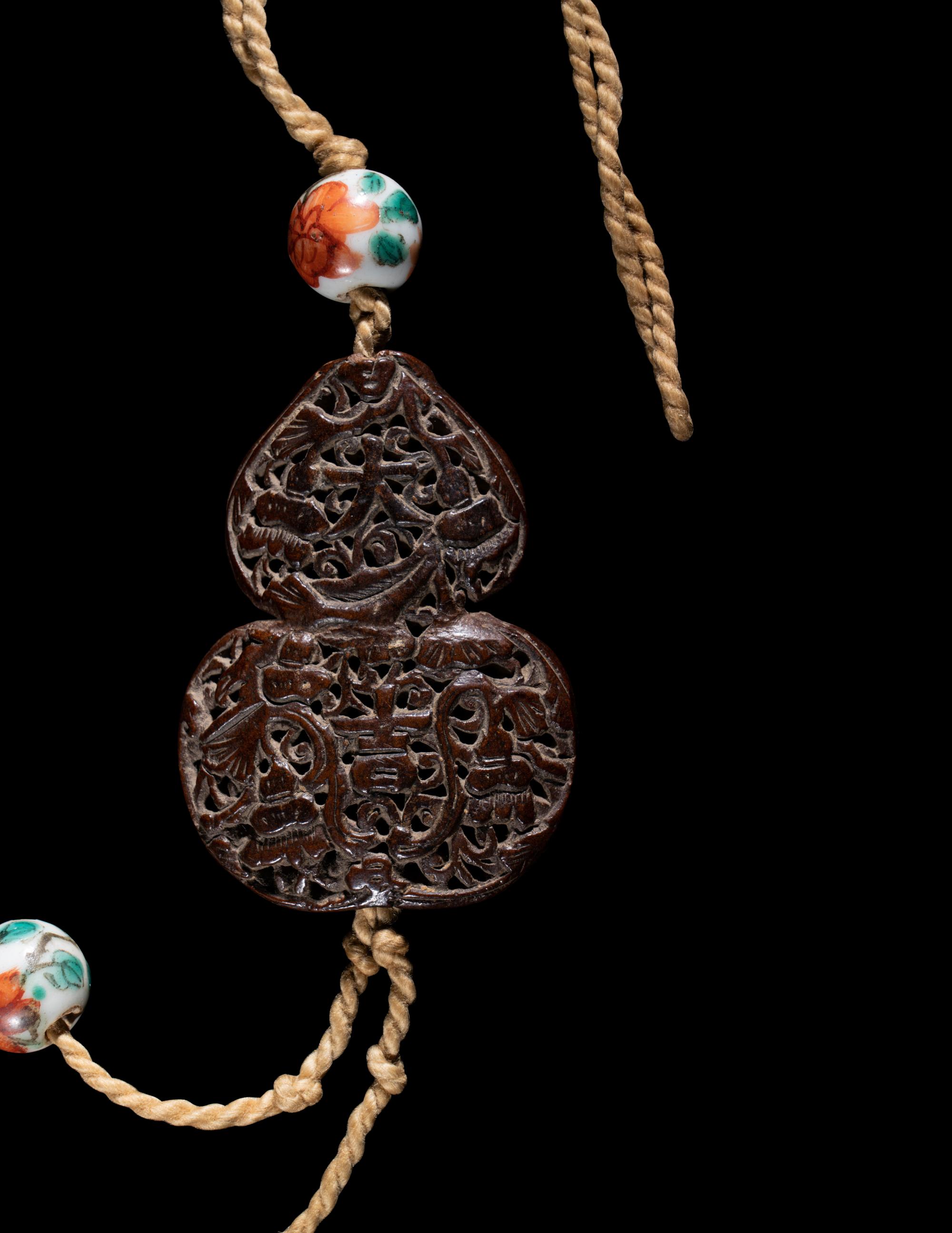 Two Chinese Carved Wood Pendants