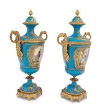 A Pair of Sèvres Style Gilt Bronze Mounted Porcelain Urns