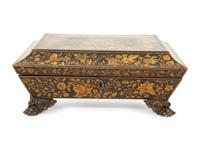A Regency Black and Gilt Lacquer Box on Brass Paw Feet