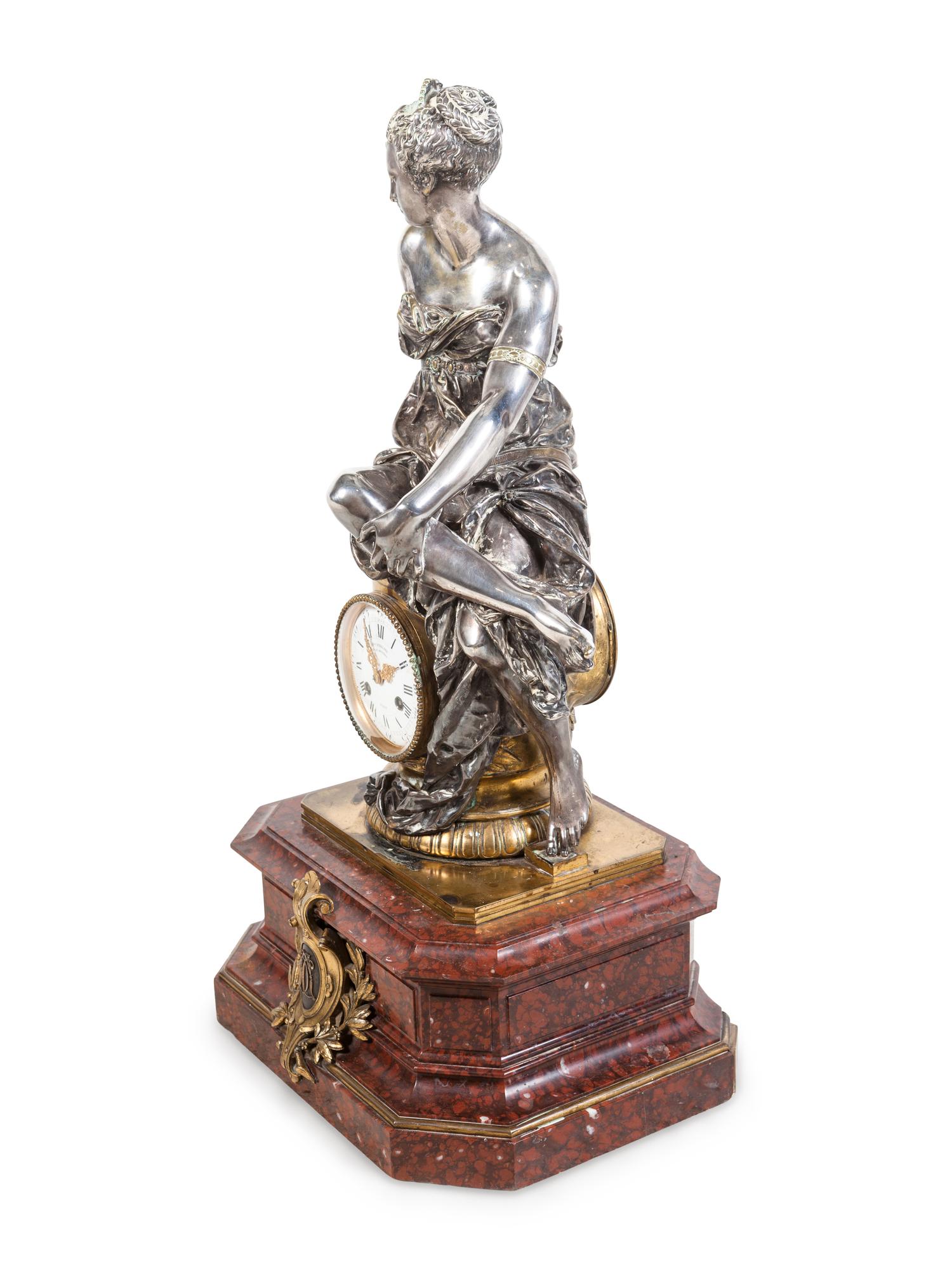 A Napoleon III Gilt and Silvered Bronze and Rouge Griotte Marble Figural Clock