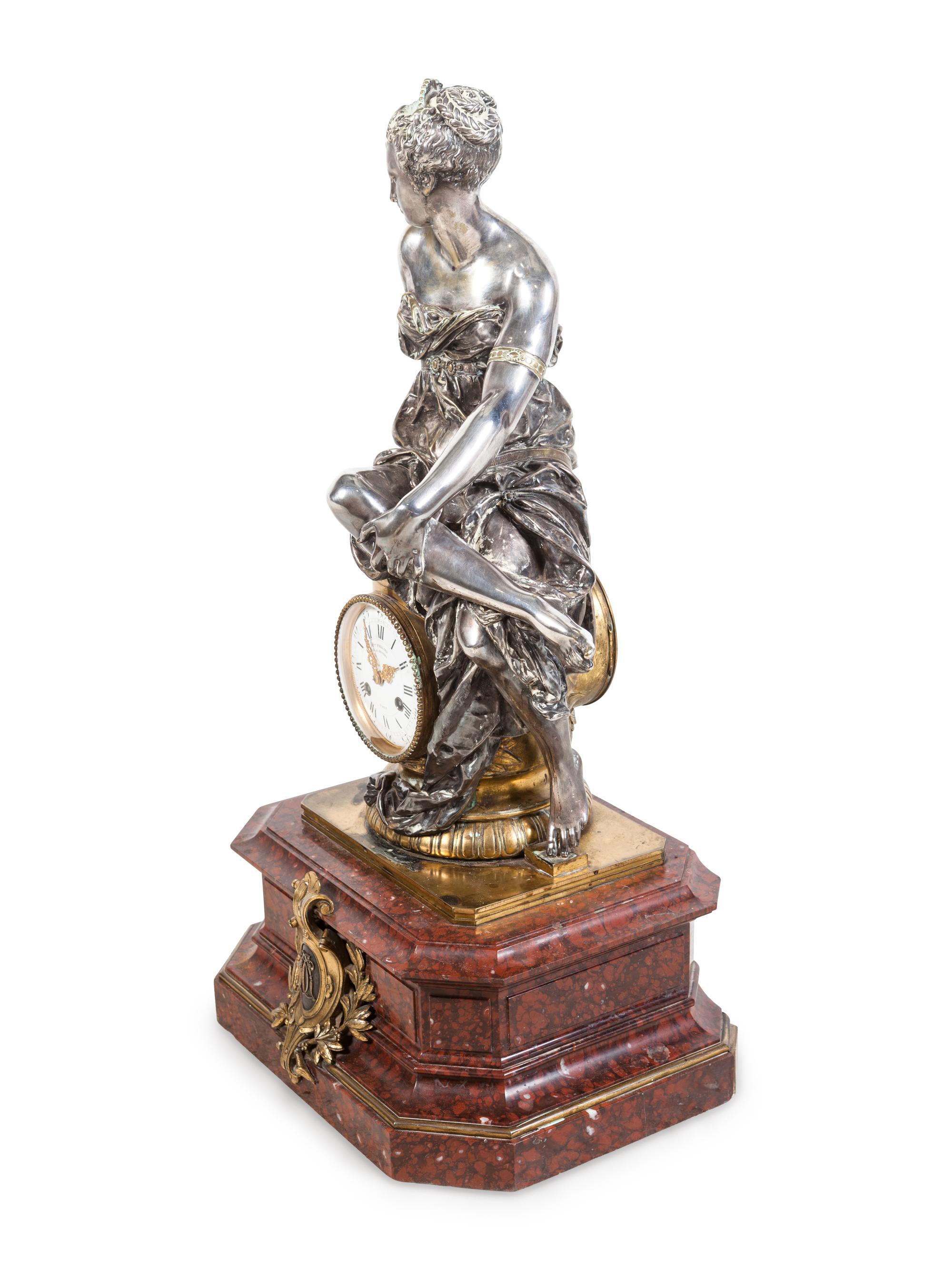 A Napoleon III Gilt and Silvered Bronze and Rouge Griotte Marble Figural Clock