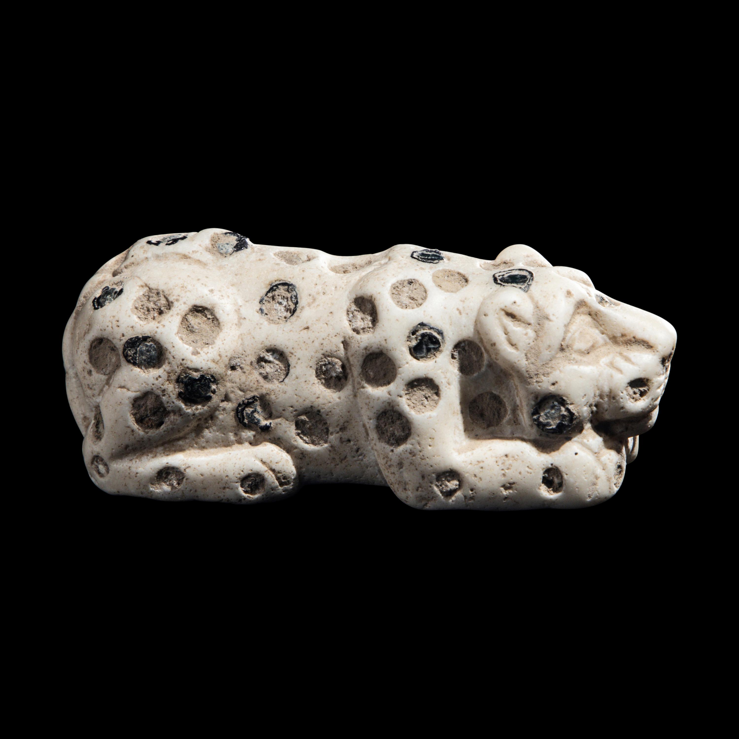 A Mesopotamian Marble and Lapis Lazuli Inlay Recumbent Feline