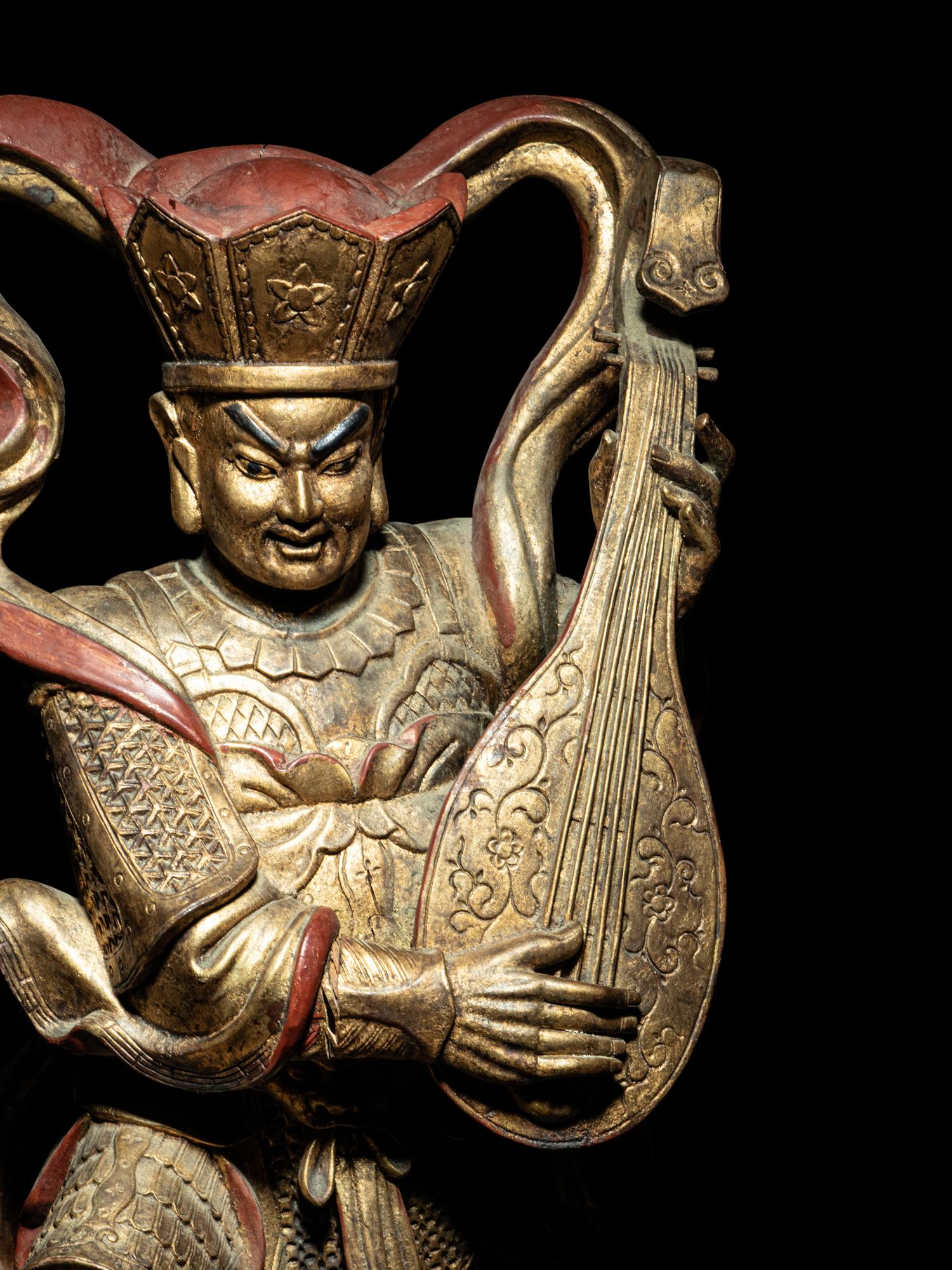 A Set of Four Gilt and Red Lacquered Wood Figures of Guardians
