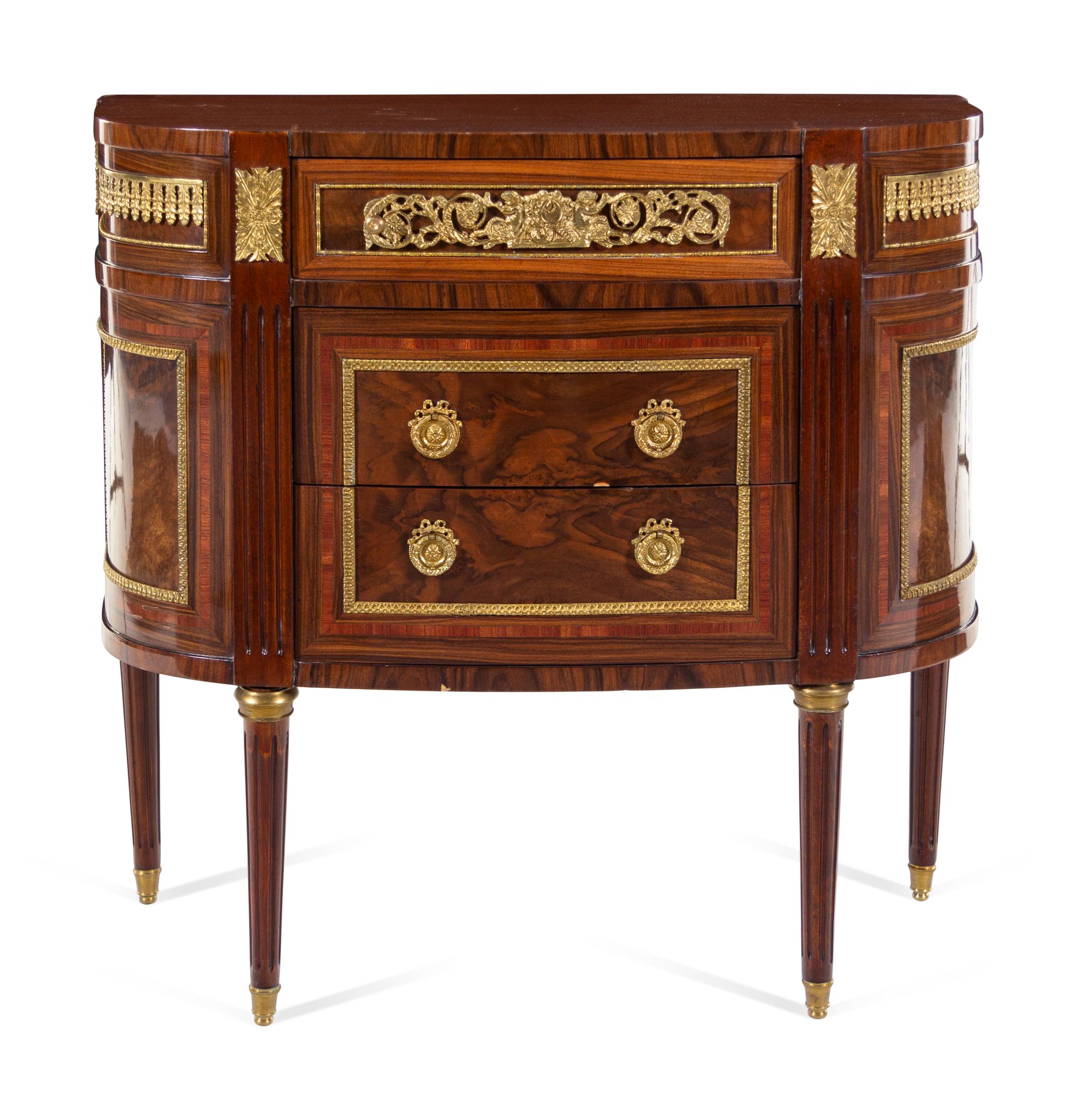 A Louis XVI Style Gilt Bronze Mounted Chest of Drawers