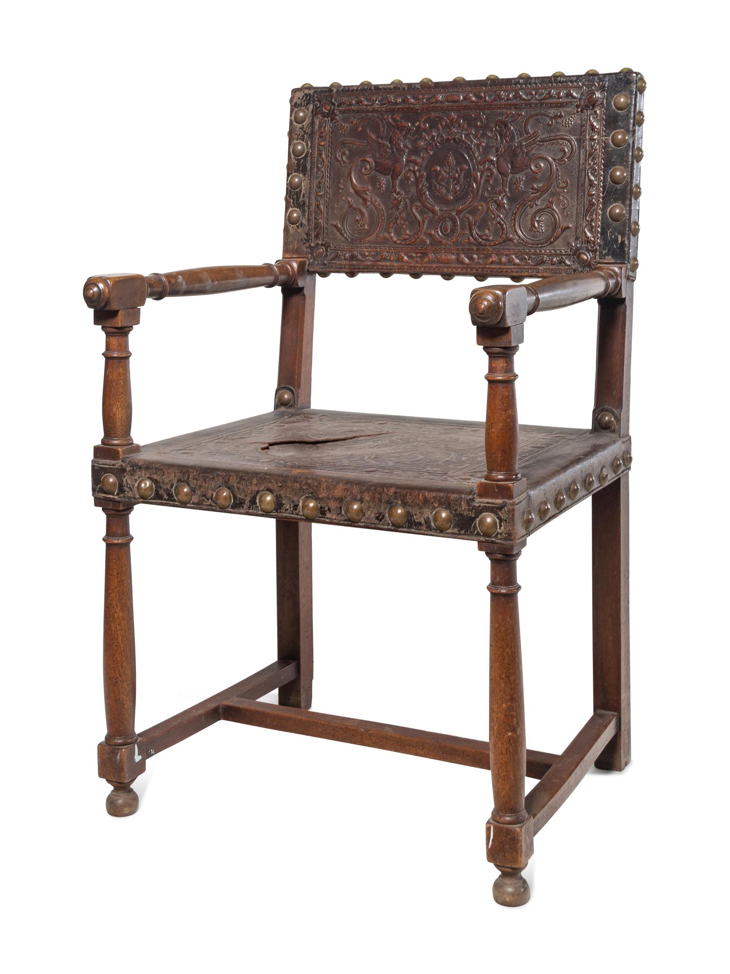 A Spanish Baroque Leather-Upholstered Walnut Armchair