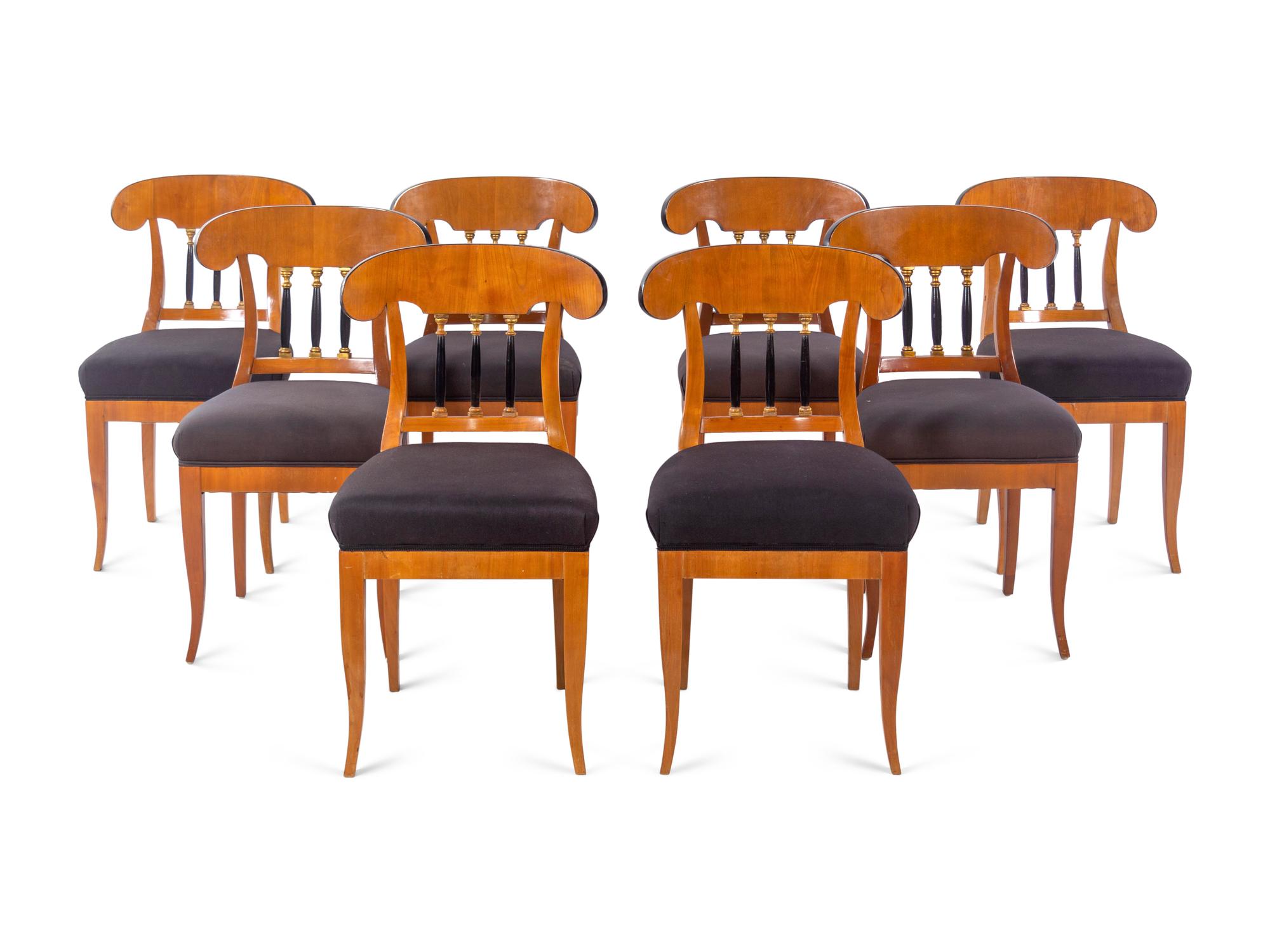 A Set of Eight Biedermeier Style Parcel Ebonized Dining Chairs