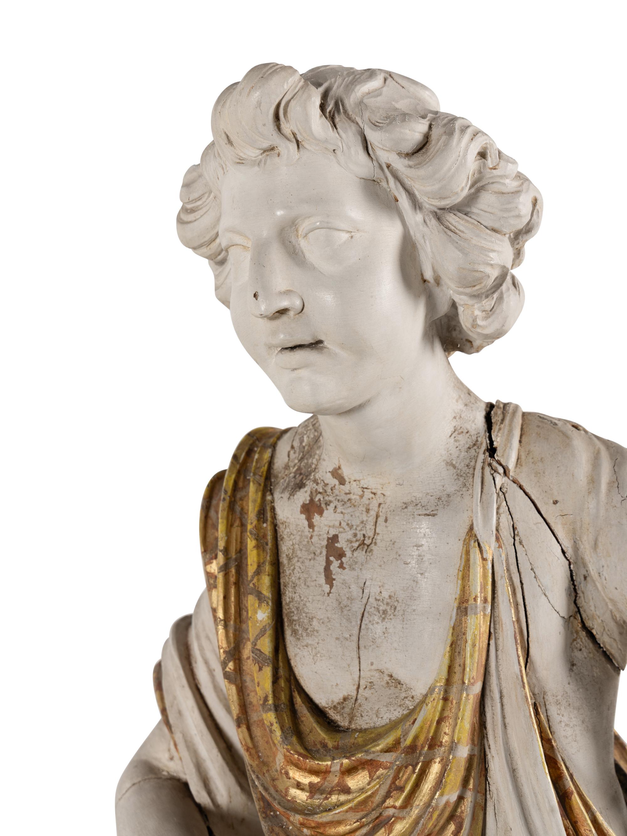 A Set of Three Carved, Painted and Parcel Gilt Wood Figures