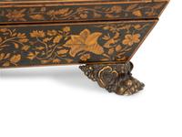 A Regency Black and Gilt Lacquer Box on Brass Paw Feet