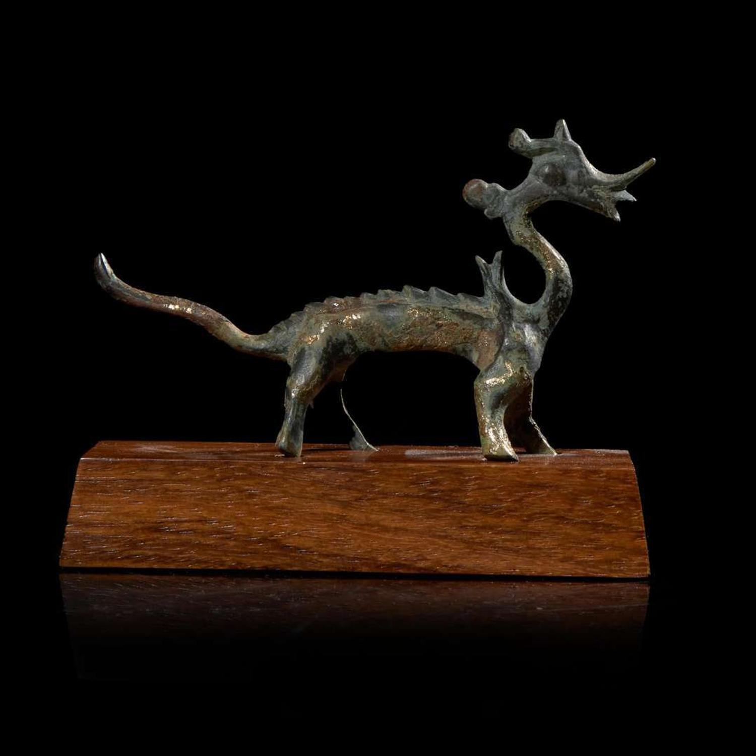 A small Chinese gilt-bronze figure of a striding dragon 铜鎏金行龙 Six dynasties to Tang dynasty ????