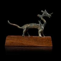 A small Chinese gilt-bronze figure of a striding dragon 铜鎏金行龙 Six dynasties to Tang dynasty ????