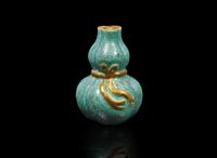 A small Chinese "Robin's-Egg"-glazed molded lobed double-gourd cabinet vase, Qing dynasty 爐鈞釉小葫蘆瓶 清