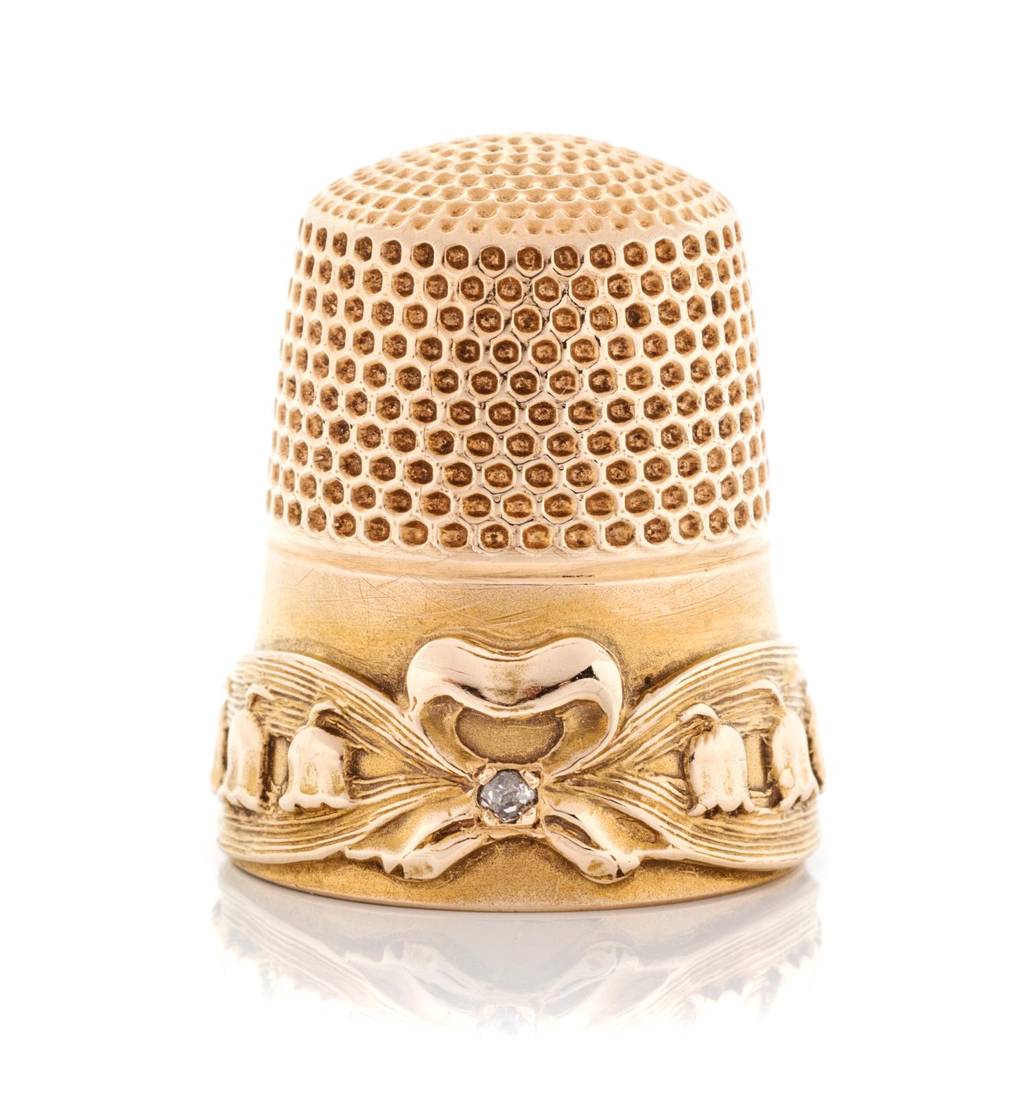 An American 14-Karat Gold and Diamond Thimble, Goldsmith, Stern & Co., New York, NY, the knurled top and body above a ribbon and bellfl
