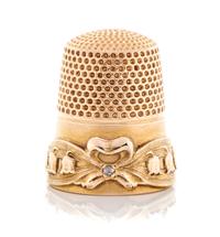 An American 14-Karat Gold and Diamond Thimble, Goldsmith, Stern & Co., New York, NY, the knurled top and body above a ribbon and bellfl