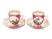 A Pair of Meissen Magenta-Ground Scenic Porcelain Teacups and Saucers