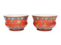 A Pair of Chinese Coral Red Ground Porcelain Cache Pots with Wood Stands
