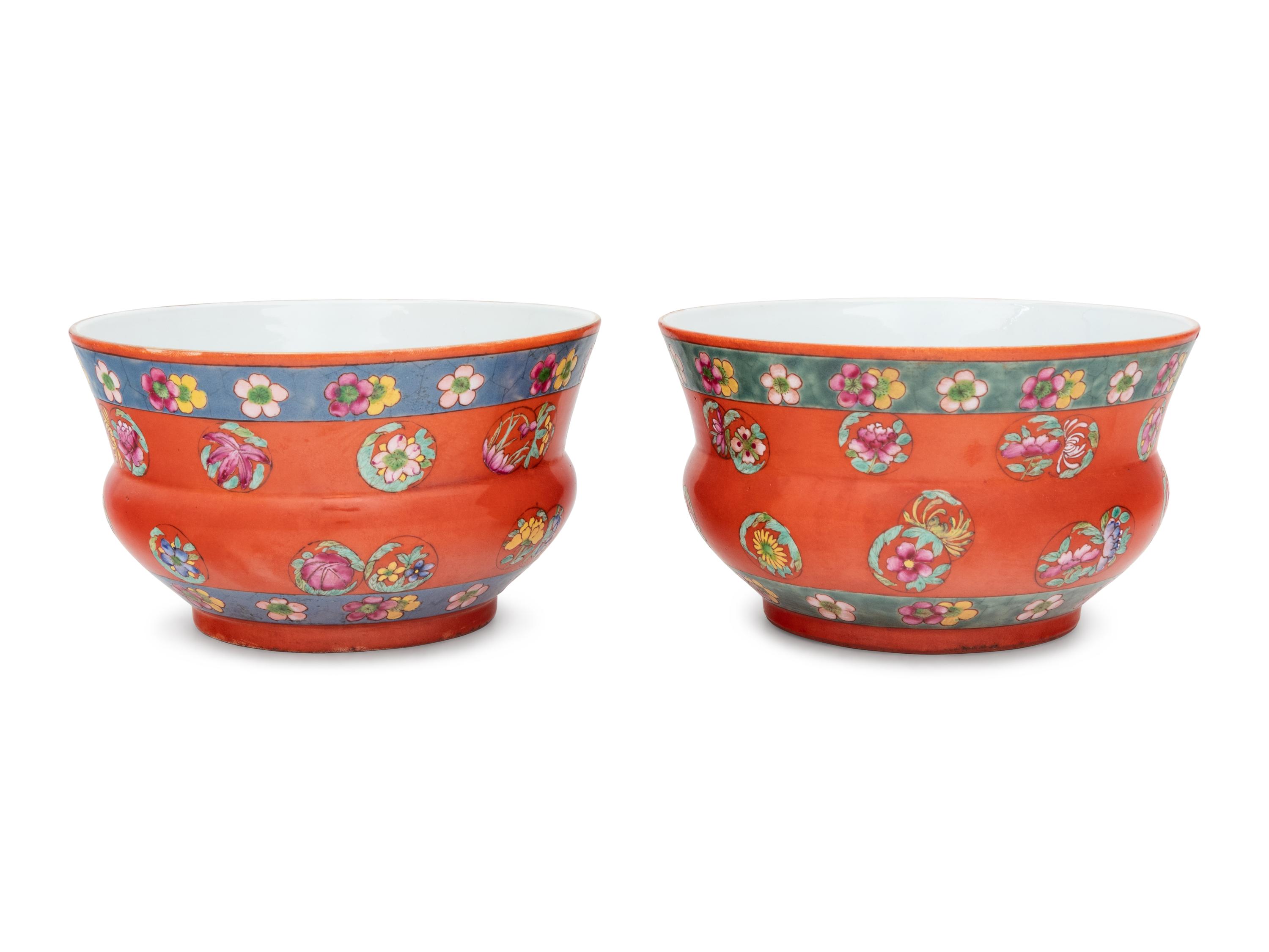 A Pair of Chinese Coral Red Ground Porcelain Cache Pots with Wood Stands