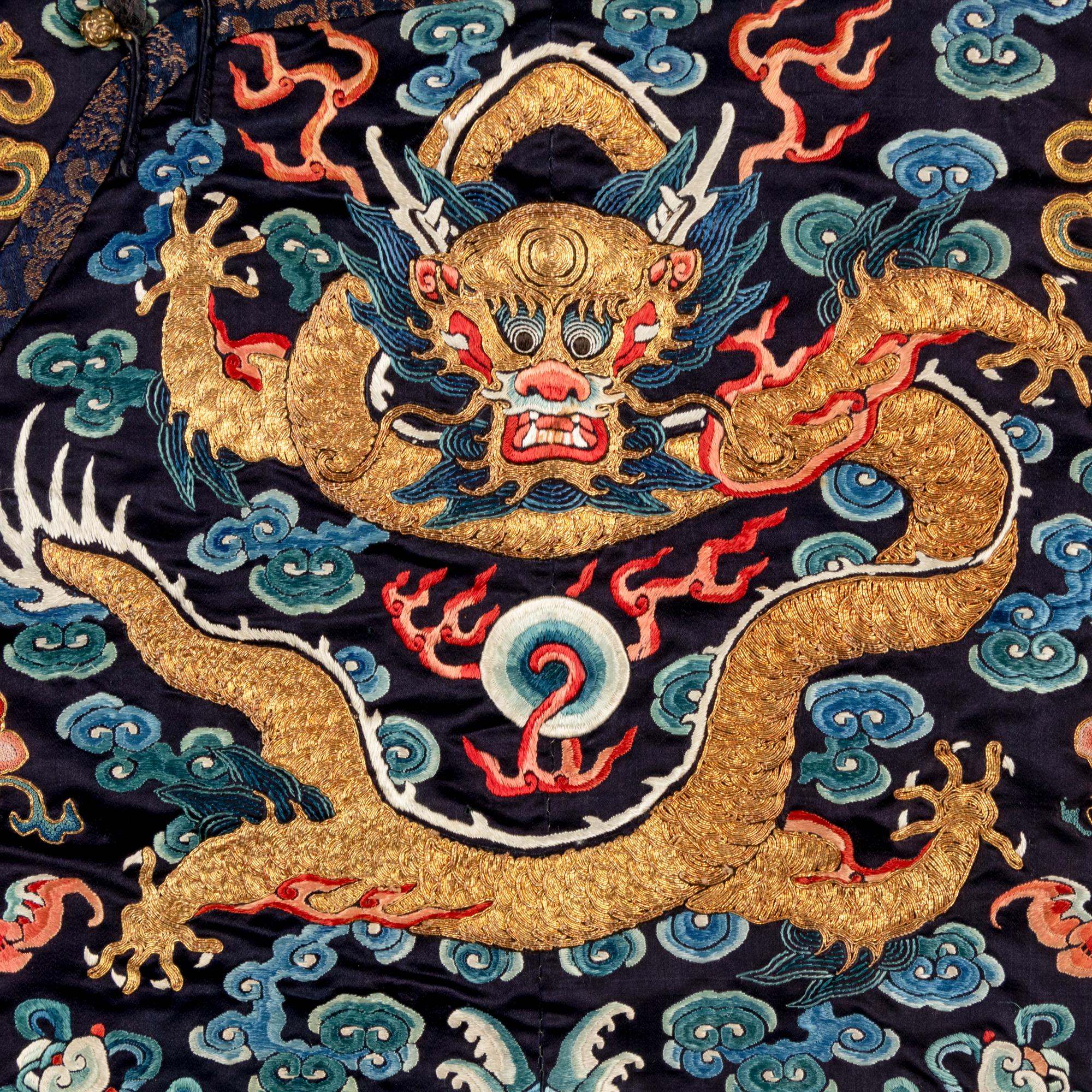 A Chinese Black Ground Embroidered Silk 'Dragon' Court Robe, Chaofugua, 19th Century 清晚期 黑緞地綉云龍紋朝服褂