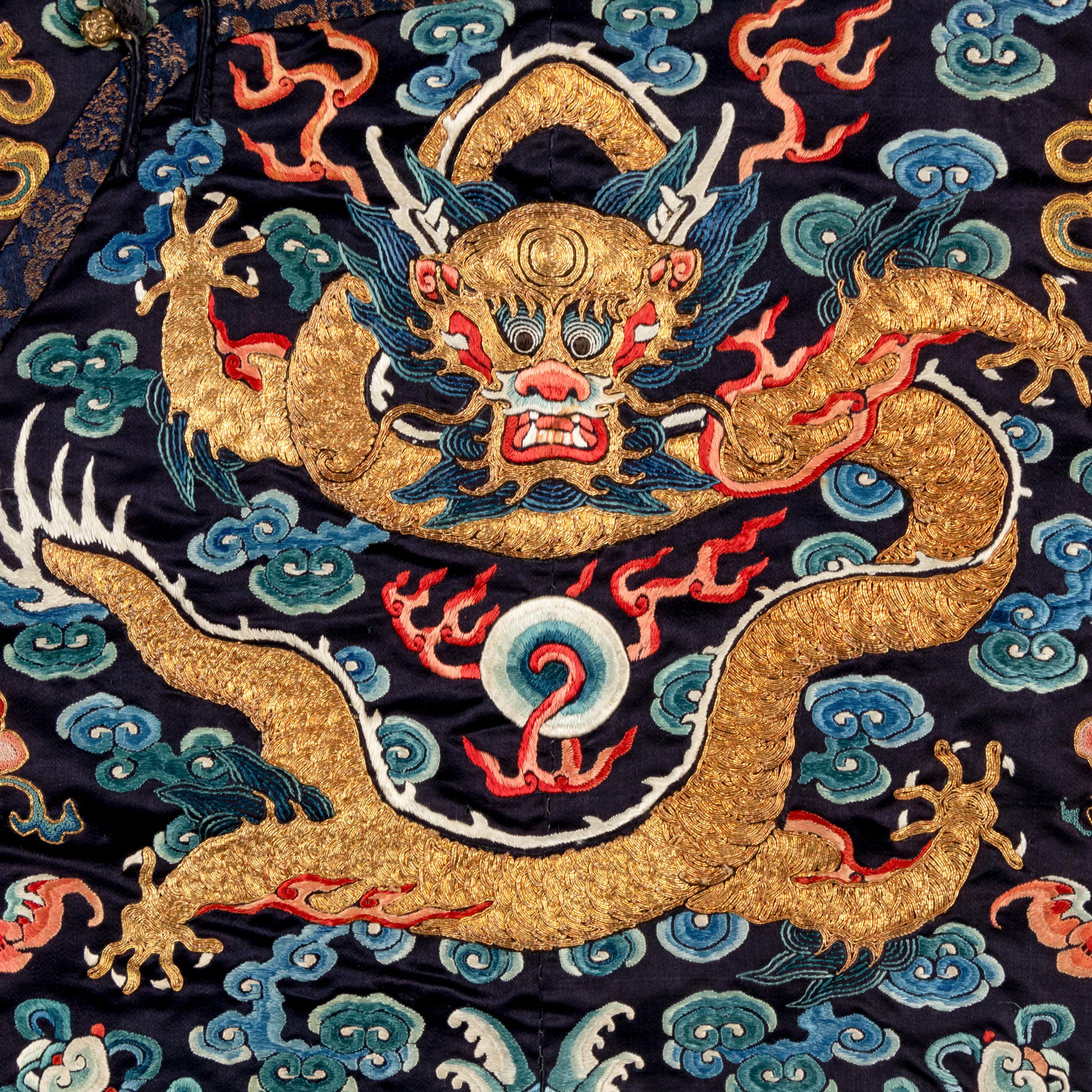 A Chinese Black Ground Embroidered Silk 'Dragon' Court Robe, Chaofugua, 19th Century 清晚期 黑緞地綉云龍紋朝服褂