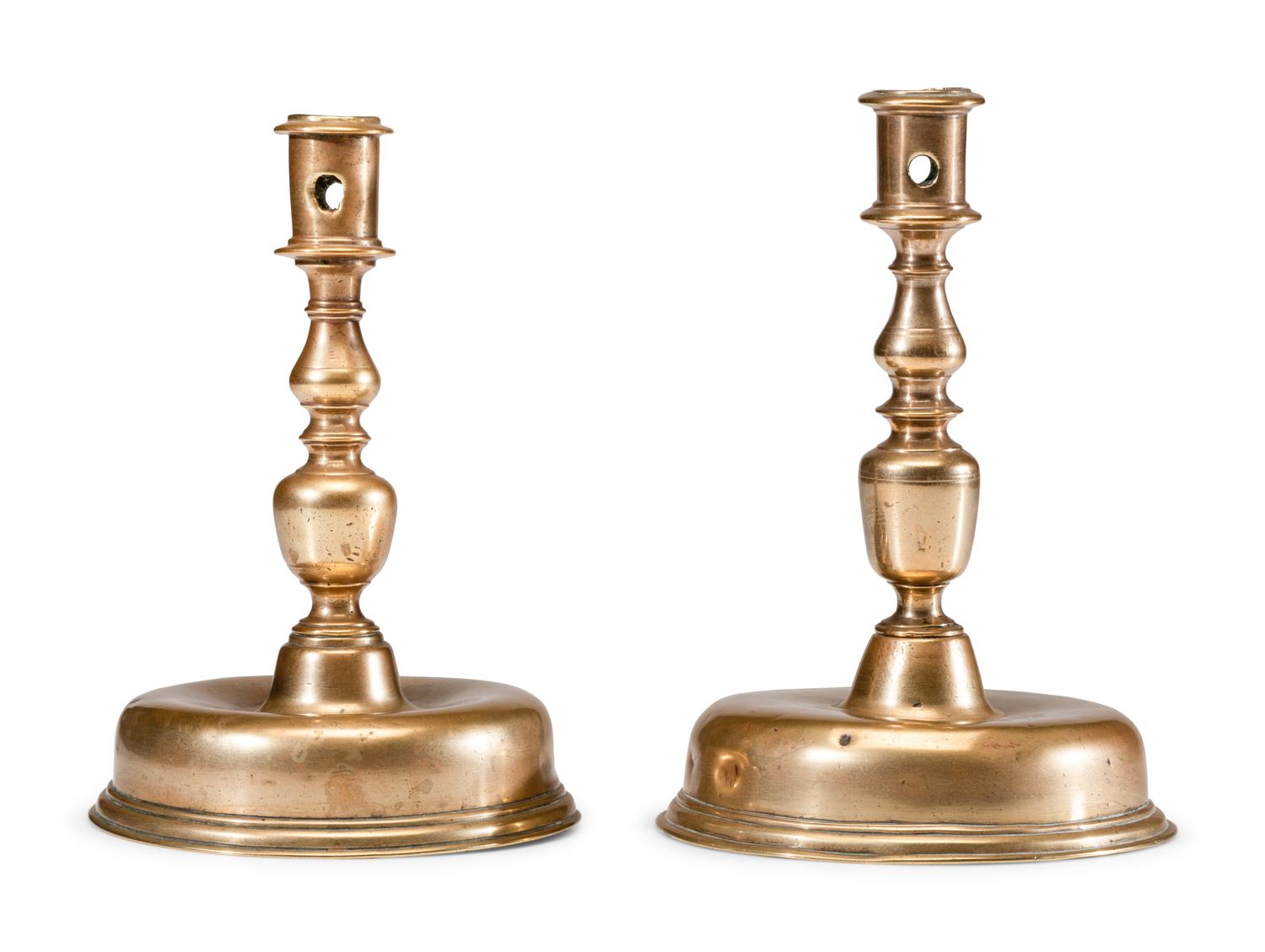 A Near Pair of Dutch William and Mary Brass Bell-Bottom Candlesticks