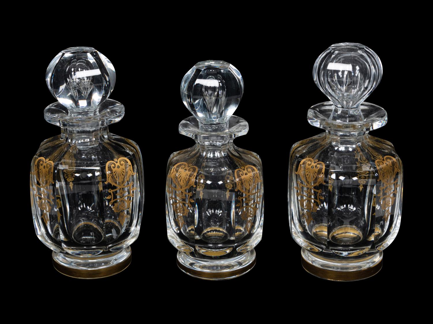 A Set of Three Baccarat Glass Decanters with Gilt Decoration