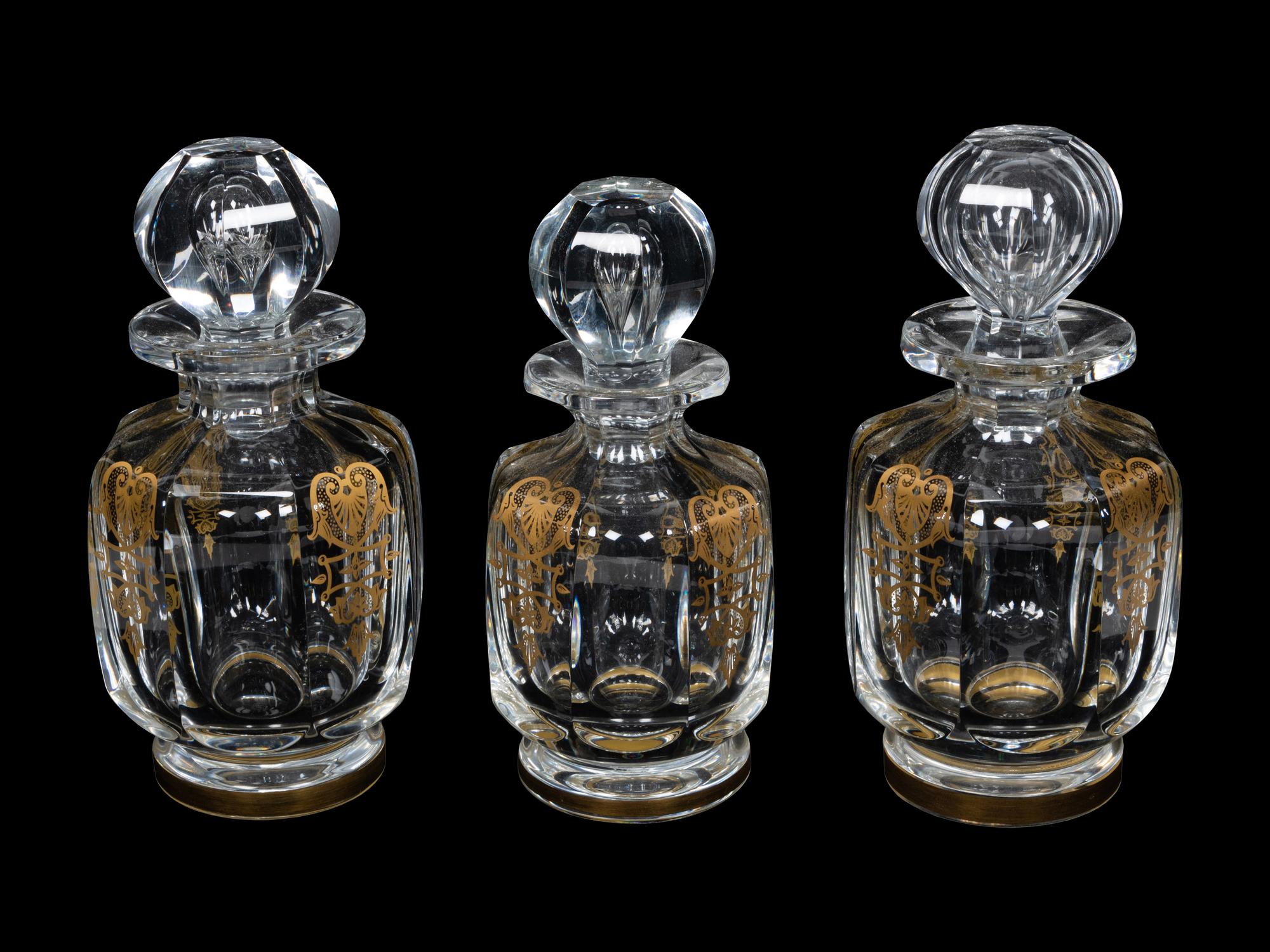 A Set of Three Baccarat Glass Decanters with Gilt Decoration