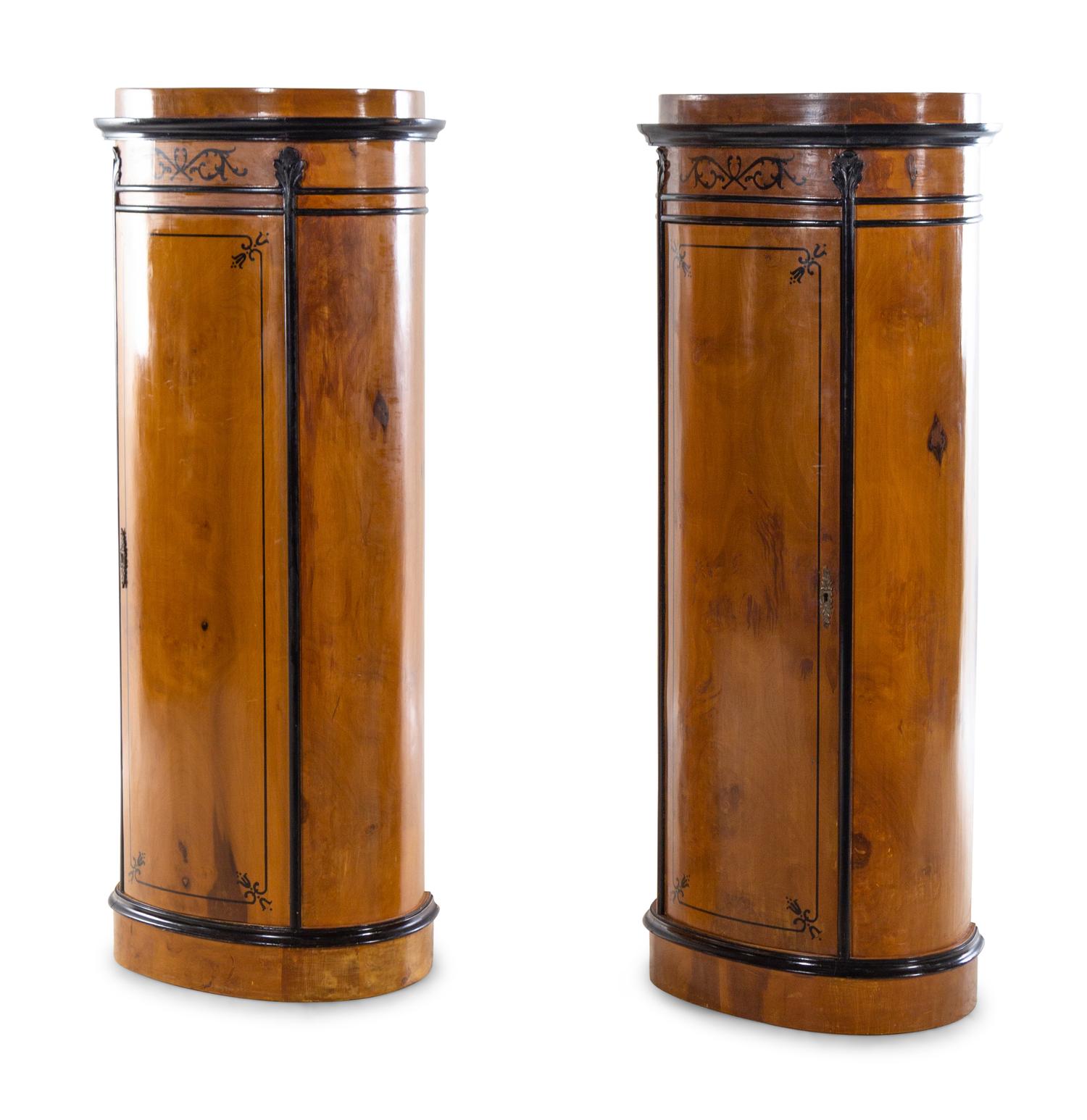 A Pair of Biedermeier Style Parcel Ebonized Satinwood Pedestal-Form Cabinets