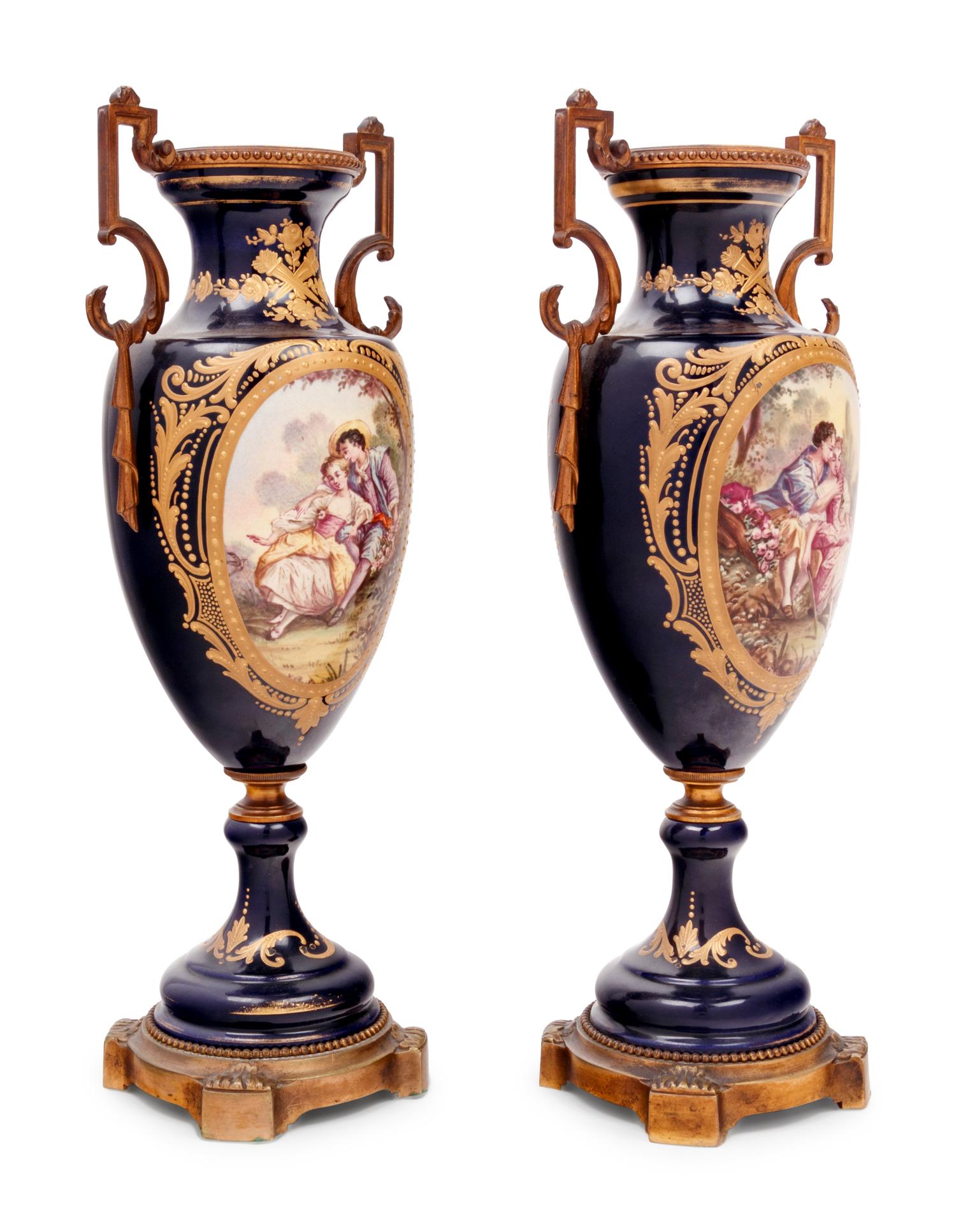 A Pair of Sèvres Style Gilt Bronze Mounted Porcelain Urns