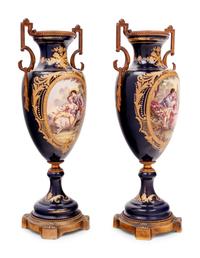 A Pair of Sèvres Style Gilt Bronze Mounted Porcelain Urns