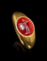 A Roman Gold and Garnet Finger Ring with the God Eros