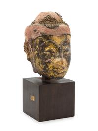 A Thai Parcel Gilt and Lacquered Terra Cotta Head of Buddha 16TH CENTURY OR EARLIER Height overall 12 3/8 inches. — 16TH CENTURY OR EARLIER