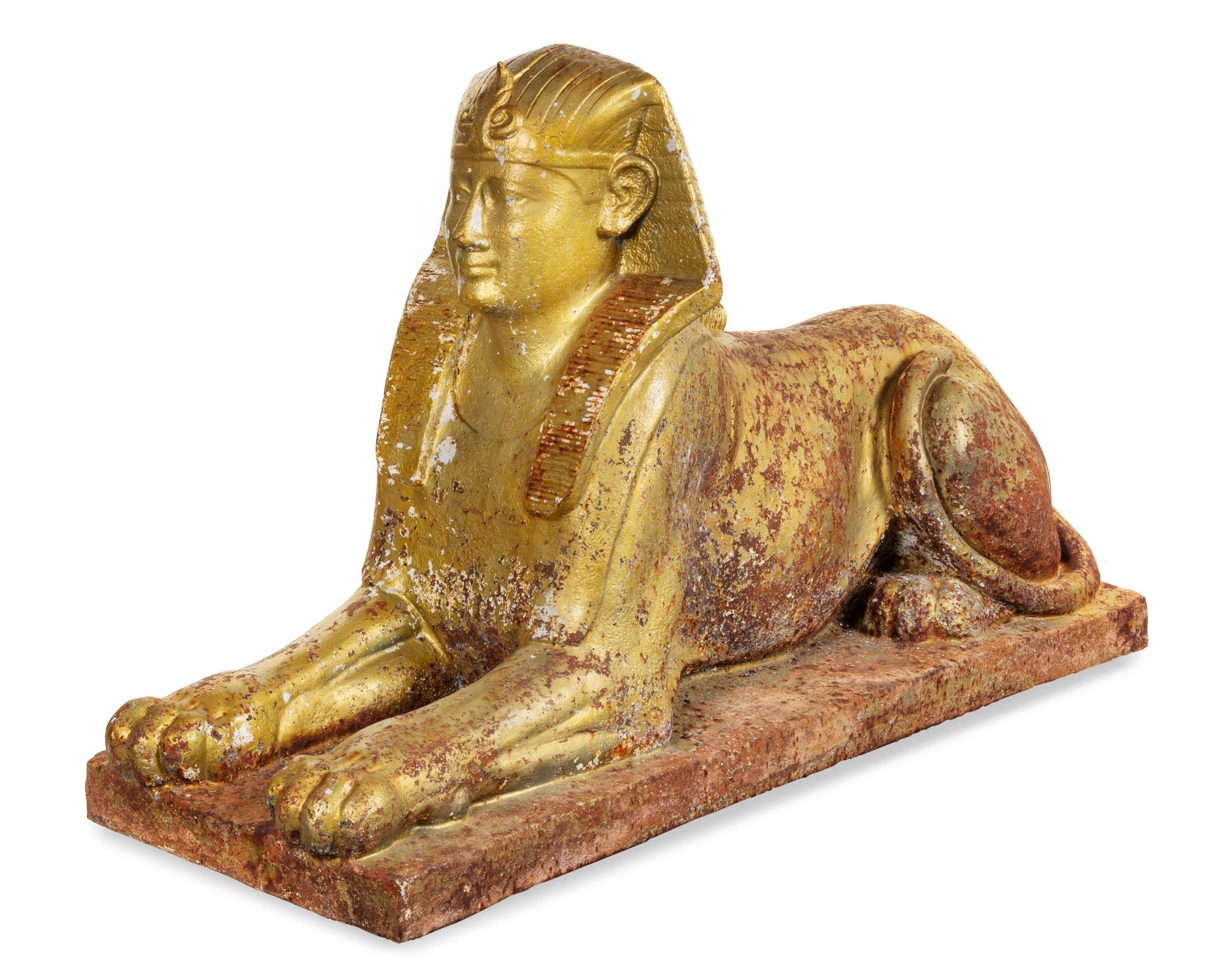 A Gold-Painted Cast Iron Model of a Sphinx Height 33 x width 19 x depth 59 inches. — 19TH CENTURY