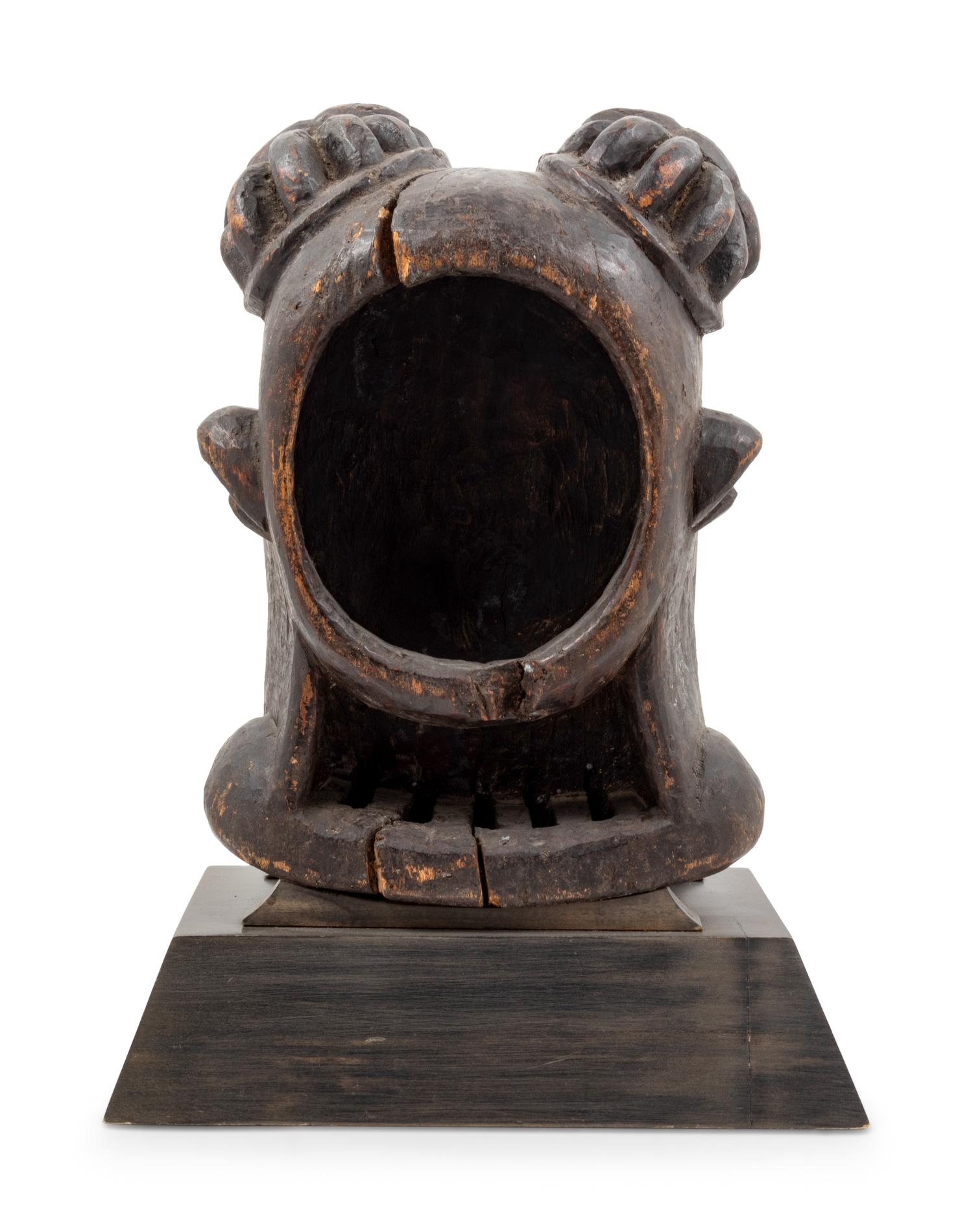 A Bamileke Carved Wood Helmet Mask