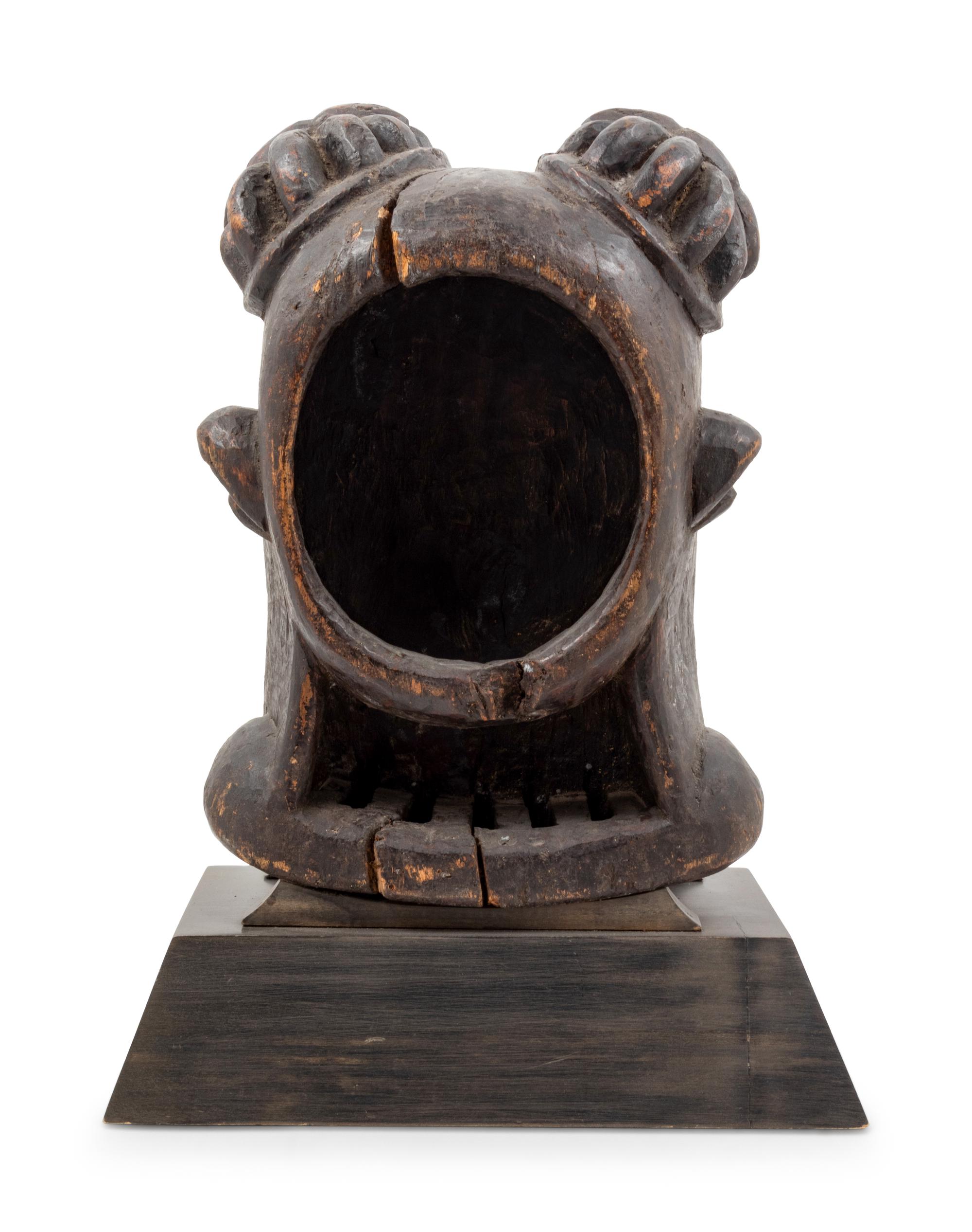 A Bamileke Carved Wood Helmet Mask