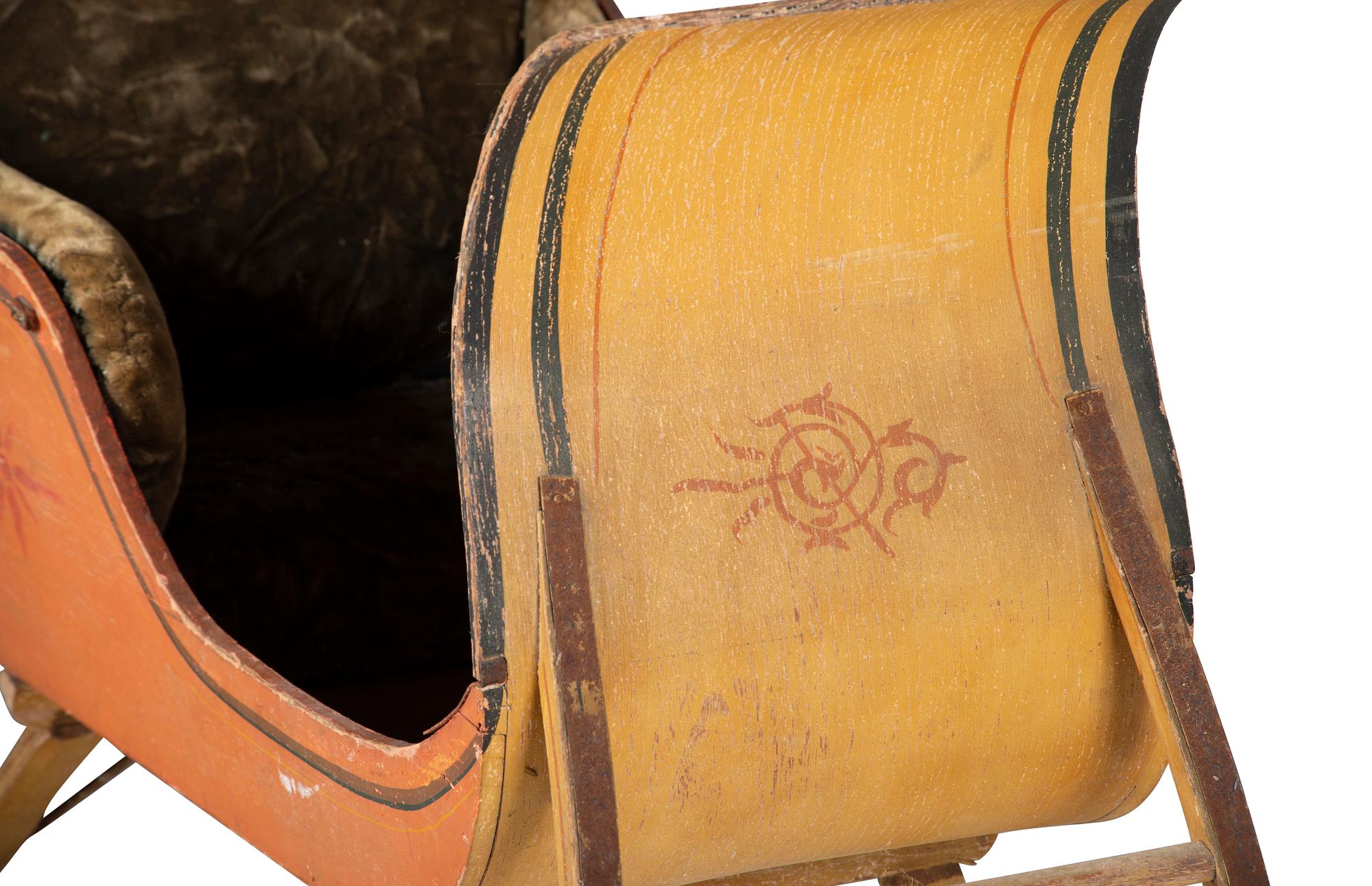 A Paint Decorated and Velvet Upholstered Wood Child's Sleigh
