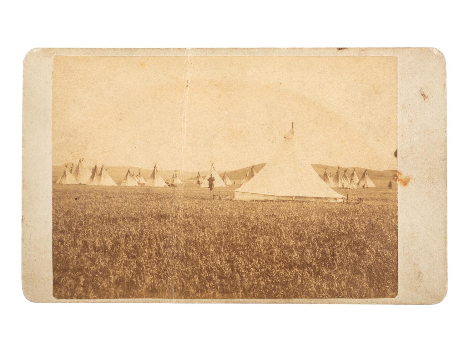 [NATIVE AMERICANS]. CROSS, William R., photographer. A group of 2 CDVs of Sioux subjects including Sitting Bull's prisoner of war camp. Niobrara, NE: n.d.