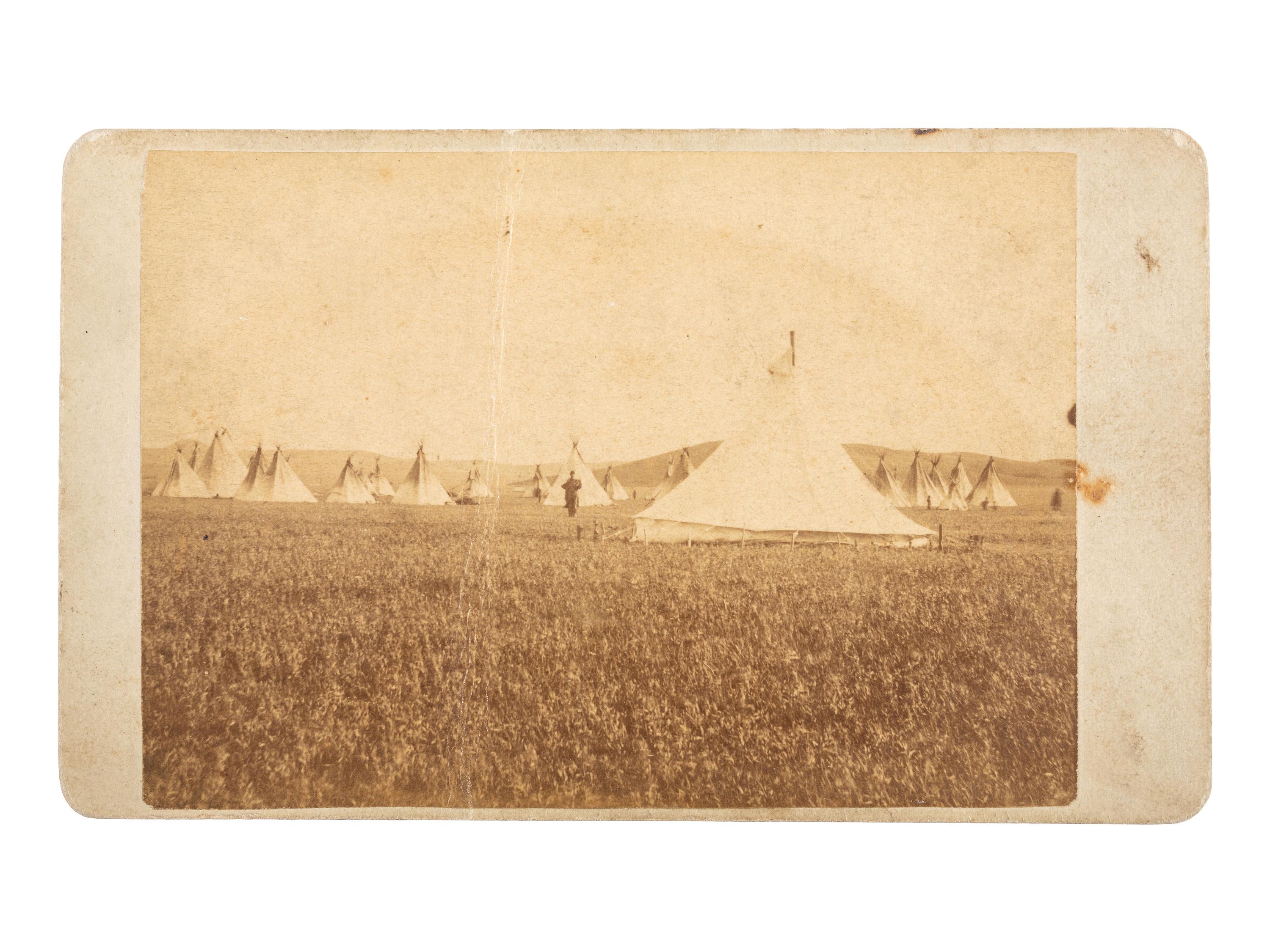 [NATIVE AMERICANS]. CROSS, William R., photographer. A group of 2 CDVs of Sioux subjects including Sitting Bull's prisoner of war camp. Niobrara, NE: n.d.