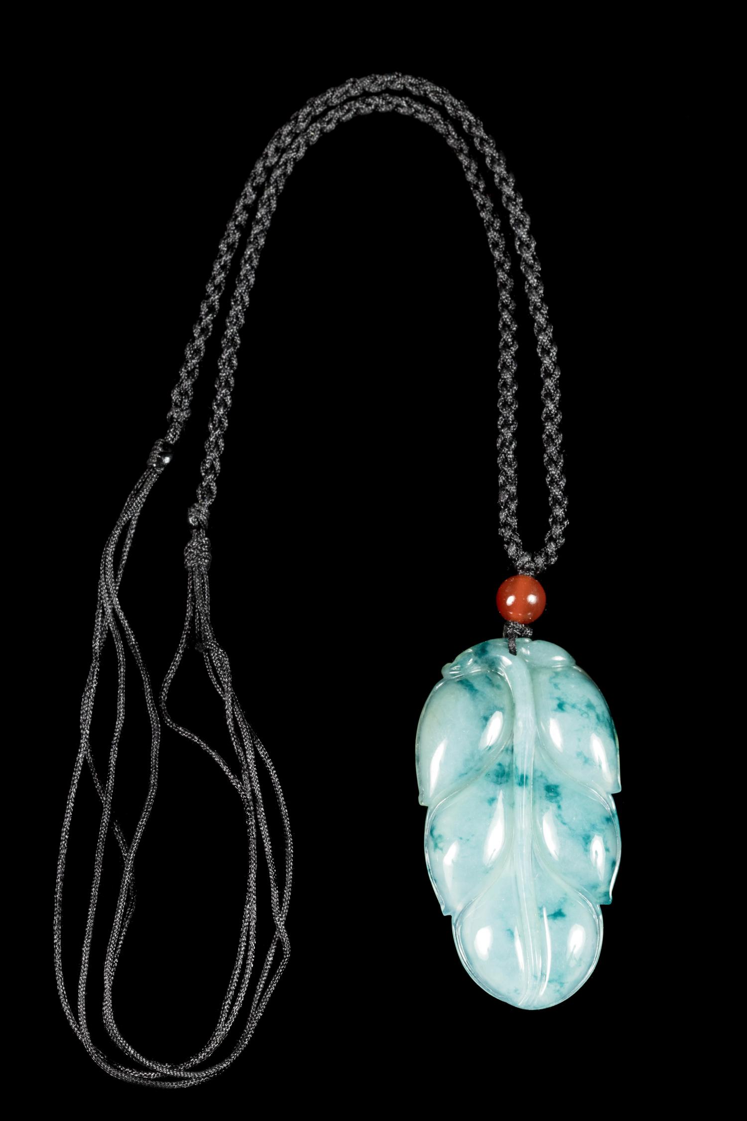 A Jadeite Leaf-Form Pendant Length 1 3/4 inches. — 20TH CENTURY