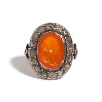 A Neoclassical Silver and Carnelian Finger Ring with a Portrait Head of a Woman Inside a Halo of Diamonds
