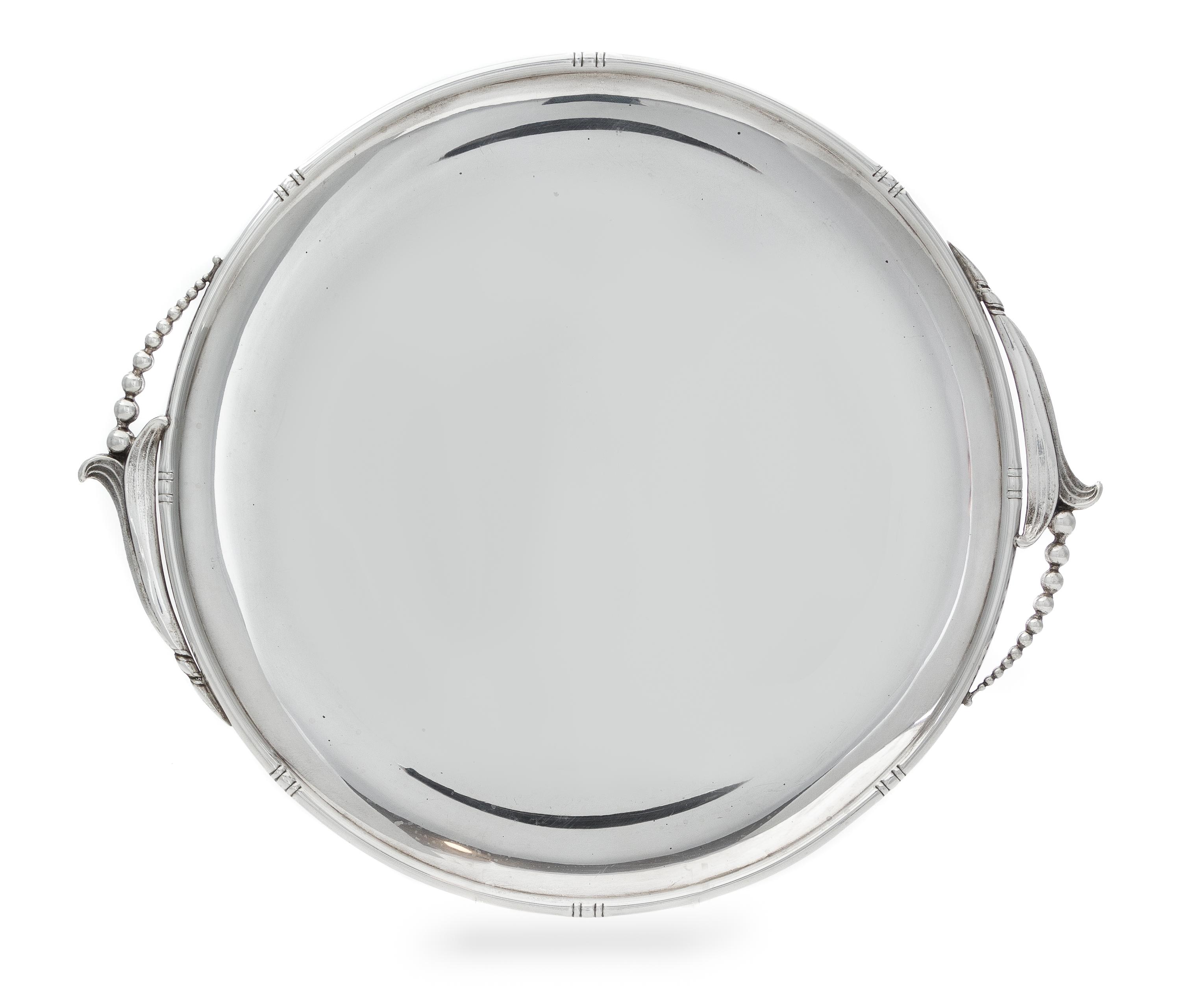 An American Silver Serving Tray, Woodside Sterling Co., New York, NY, Early 20th Century, of circular form with blossom form handles.