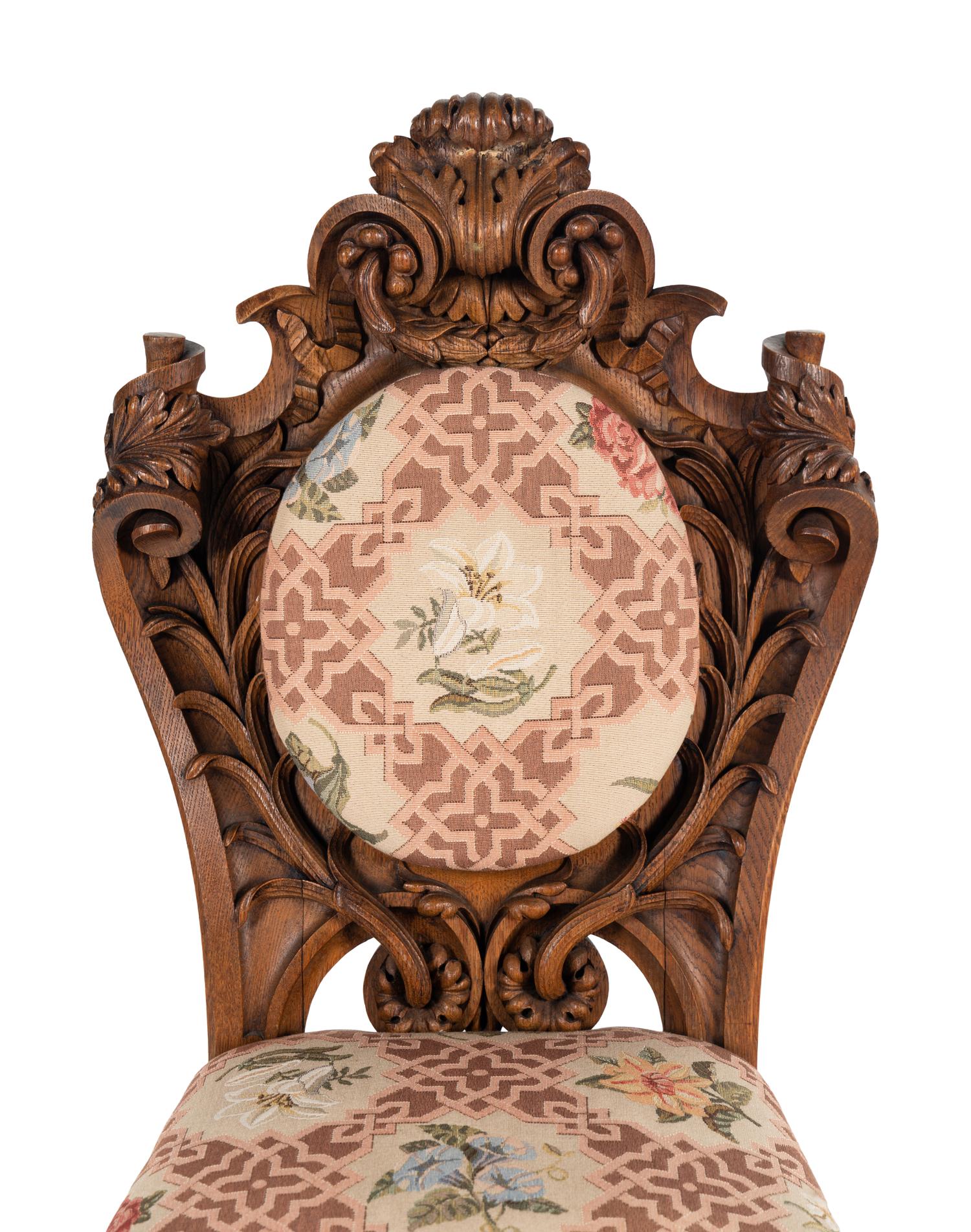 A Set of Six Rococo Revival Carved Oak Dining Chairs