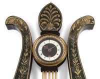A Regency Ebonized and Parcel Gilt Eagle's Head Lyre-Form Bracket Clock