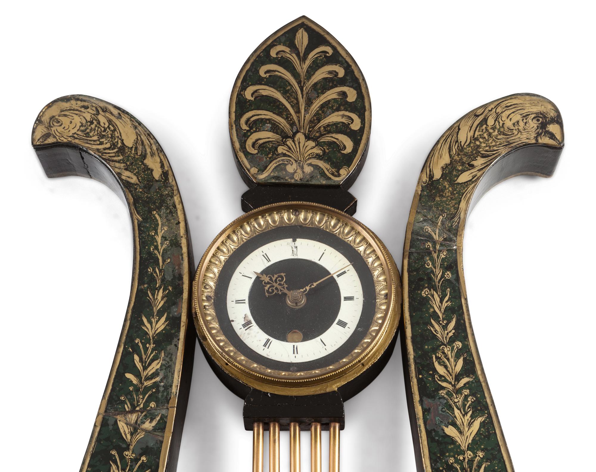 A Regency Ebonized and Parcel Gilt Eagle's Head Lyre-Form Bracket Clock