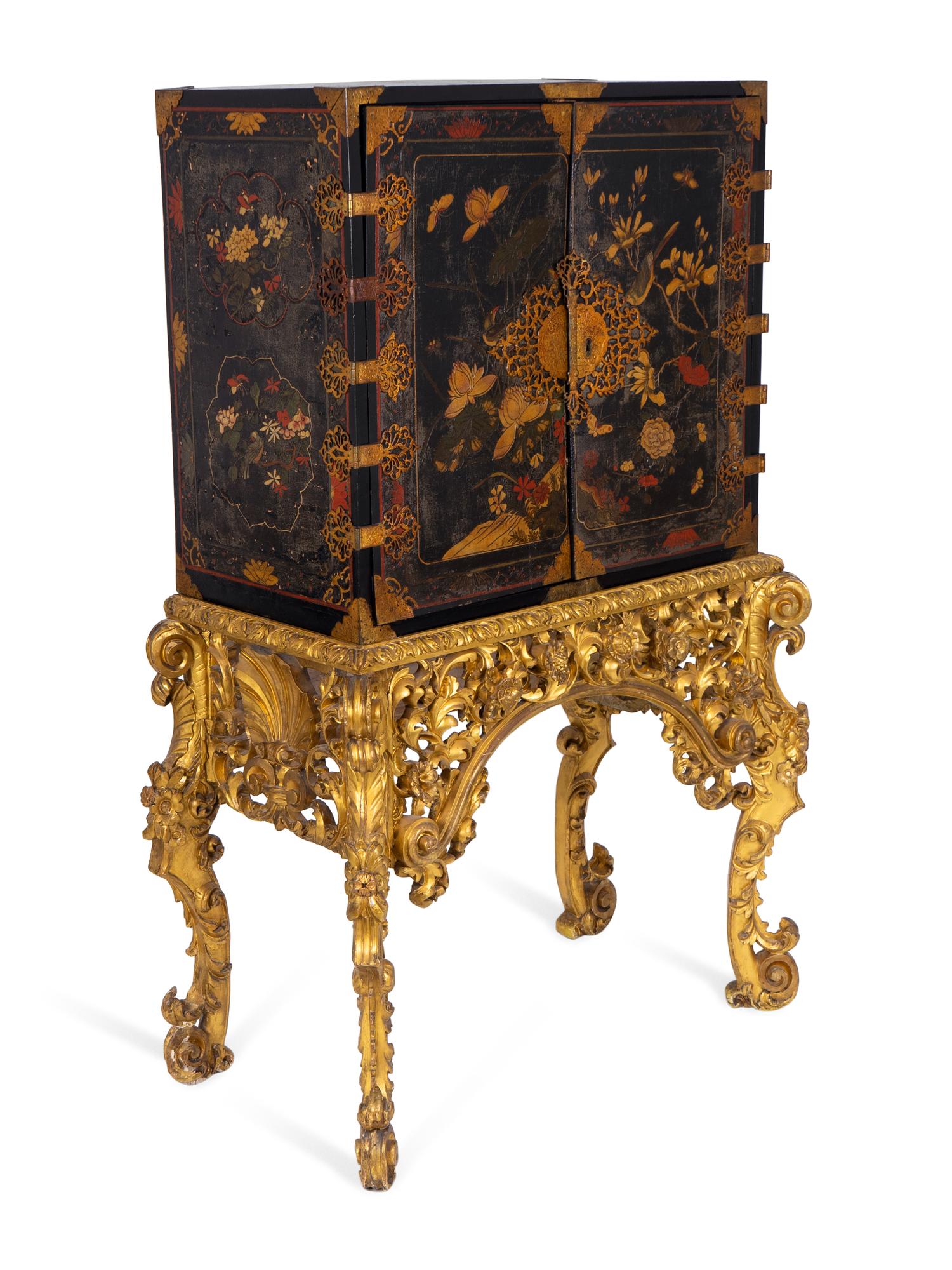 A Chinese Brass-Mounted Gilt-Decorated Black Lacquer Cabinet on Later Giltwood Stand — 18TH/19TH CENTURY