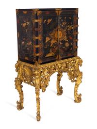 A Chinese Brass-Mounted Gilt-Decorated Black Lacquer Cabinet on Later Giltwood Stand — 18TH/19TH CENTURY