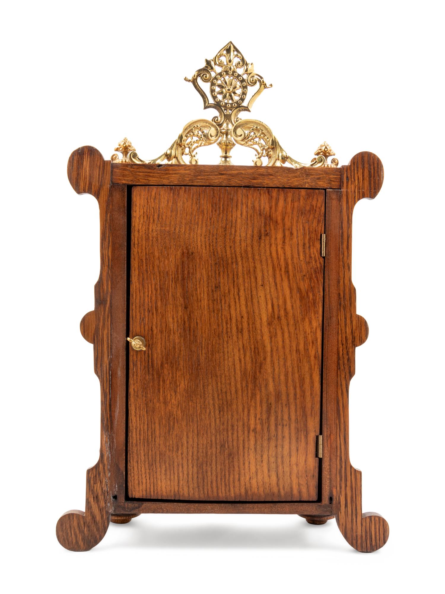 An Ansonia Cabinet B Gilt Metal Mounted Oak Shelf Clock