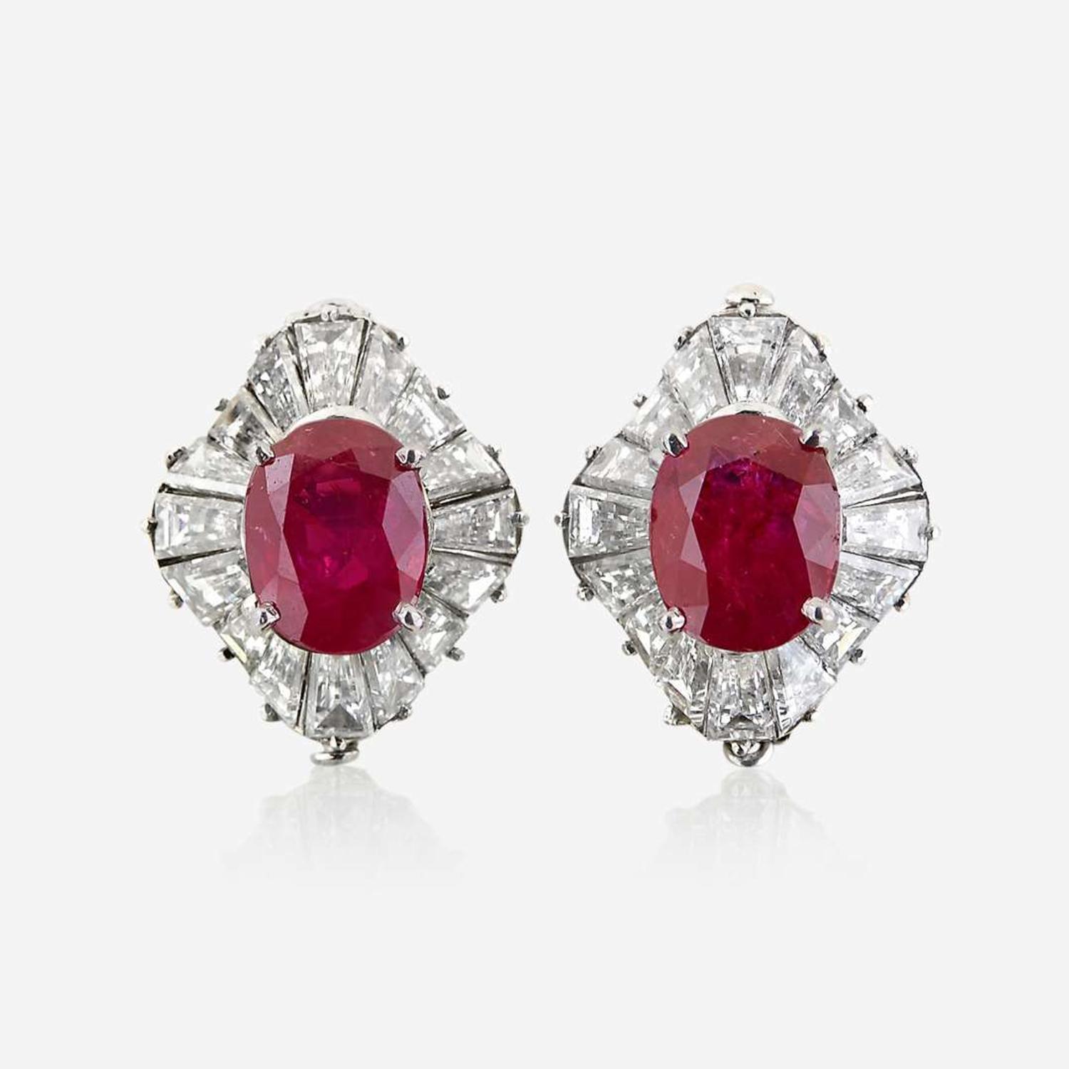 A pair of diamond and platinum earring jackets with interchangeable ruby and sapphire studs