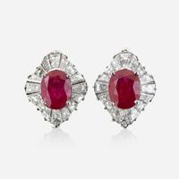 A pair of diamond and platinum earring jackets with interchangeable ruby and sapphire studs